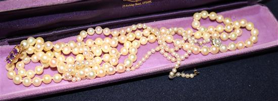 Two single strand cultured pearl necklaces, one with diamond set clasp.